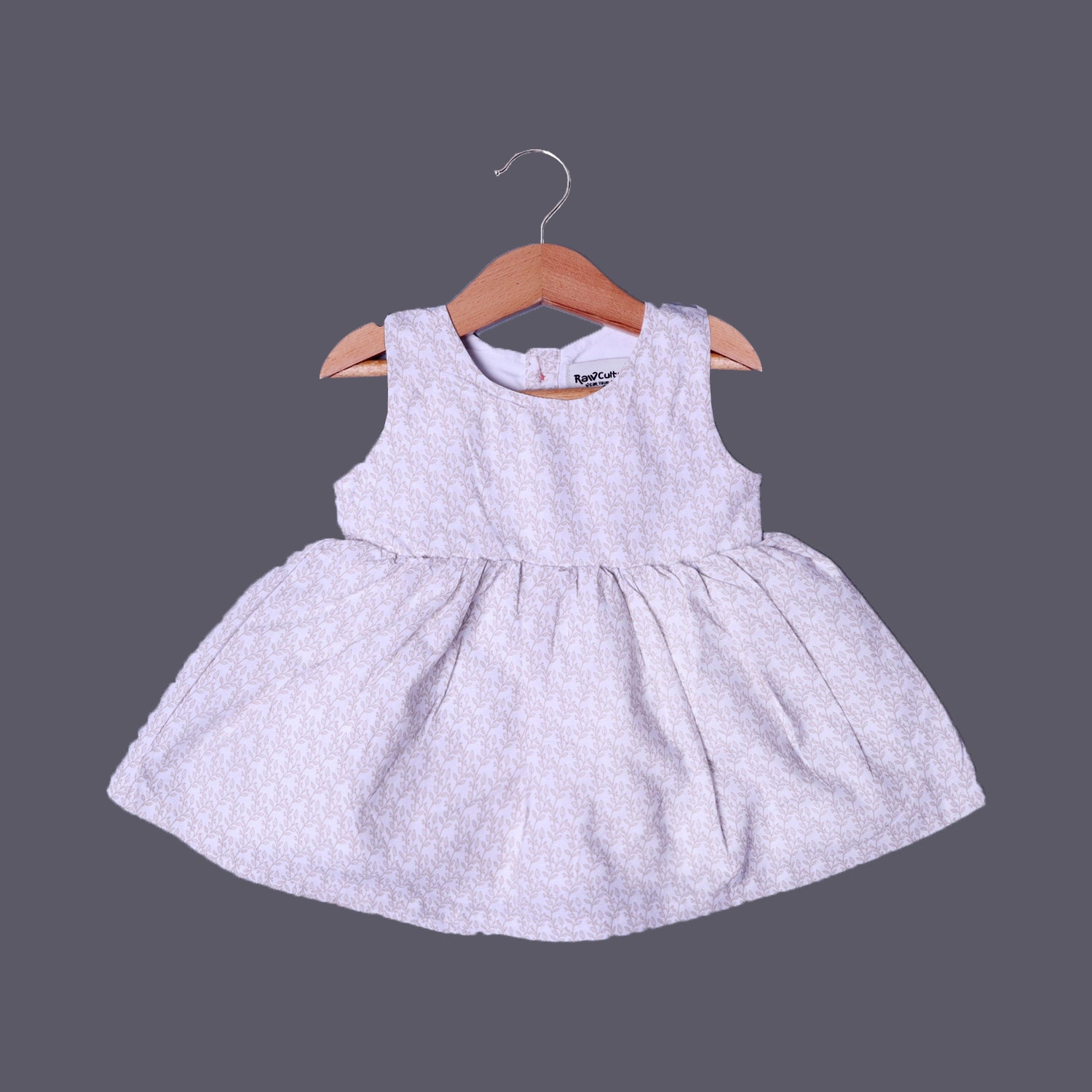 CREAM LEAVES PRINTED FRIL SLEEVES LESS COTTON FABRIC FROCK FOR GIRLS