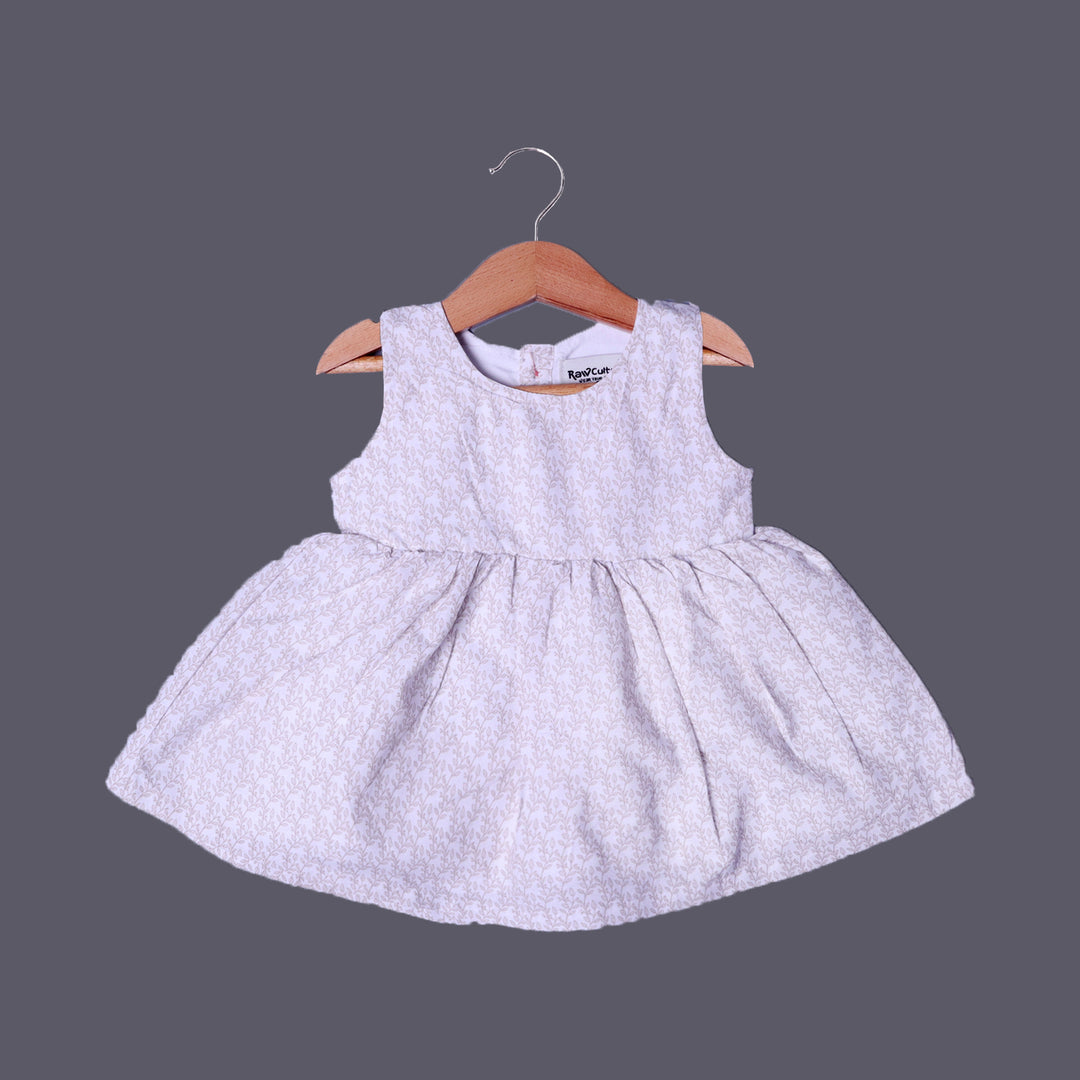 CREAM LEAVES PRINTED FRIL SLEEVES LESS COTTON FABRIC FROCK FOR GIRLS
