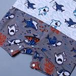Load image into Gallery viewer, WHITE WITH GREY BOAT &amp; SHARKS PRINTED HALF BODY ROMPER
